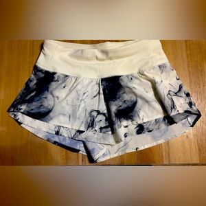 White and black athletic shorts by CALIA with built in shorts for extra coverage